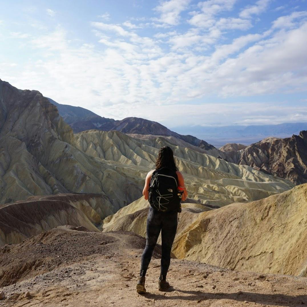 Explore dramatic yellow-gold canyons under the scorching sun of Death Valley.